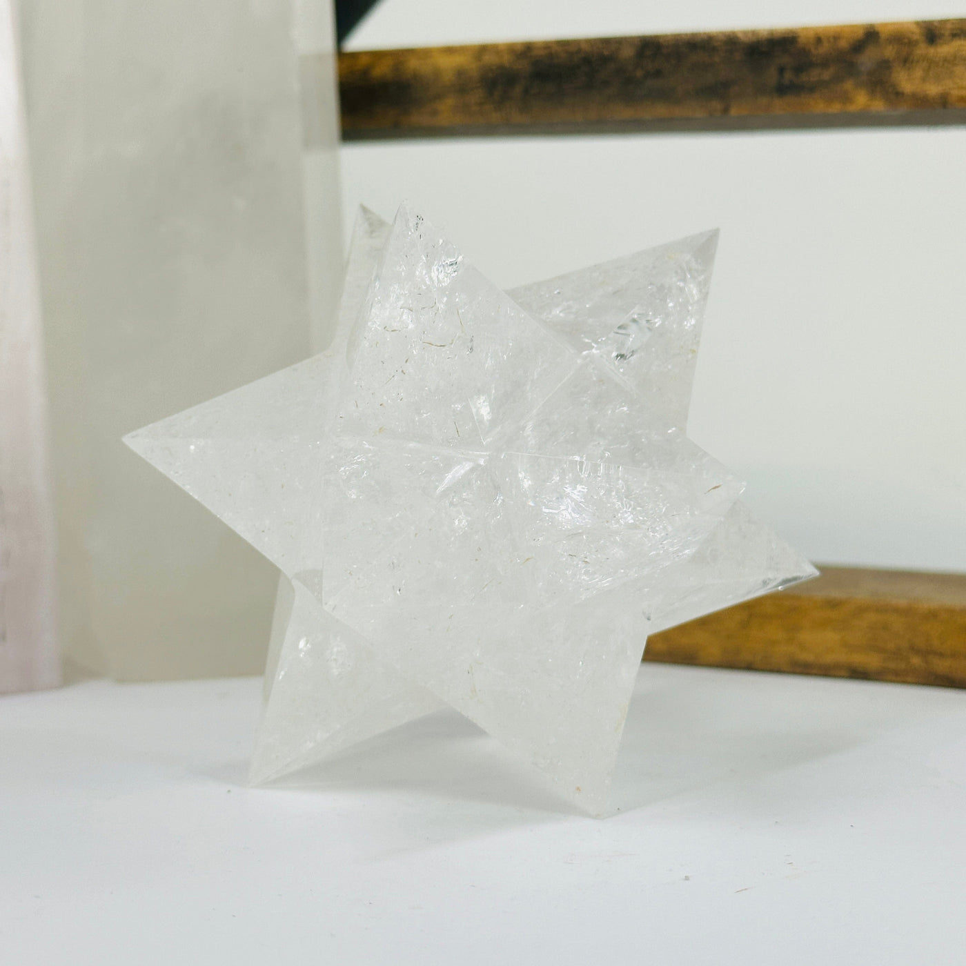 crystal quartz merkaba with decorations in the background