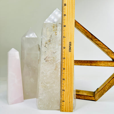 crystal quartz point next to a ruler for size reference