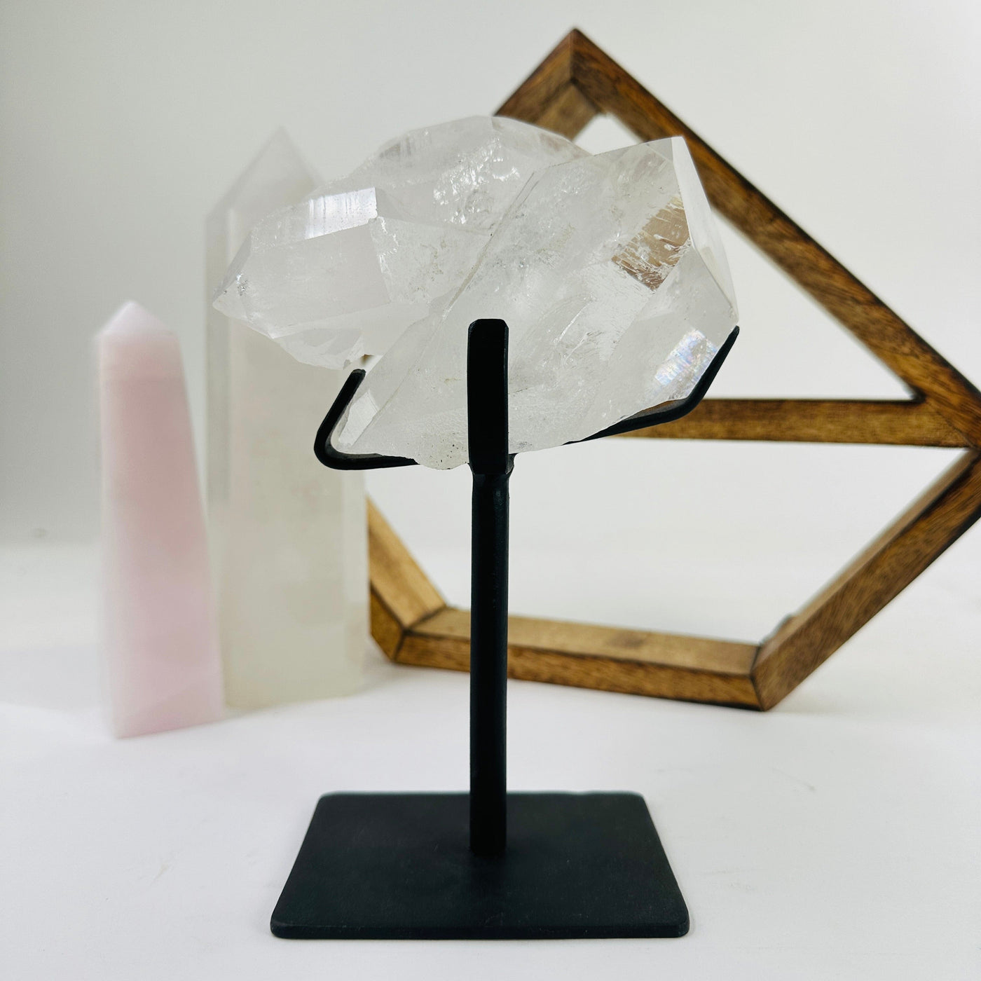 crystal quartz on metal stand with decorations in the background