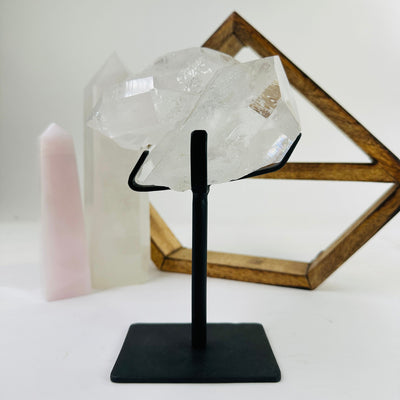 crystal quartz on metal stand with decorations in the background