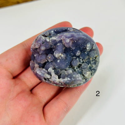 Grape agate cluster with decorations in the background