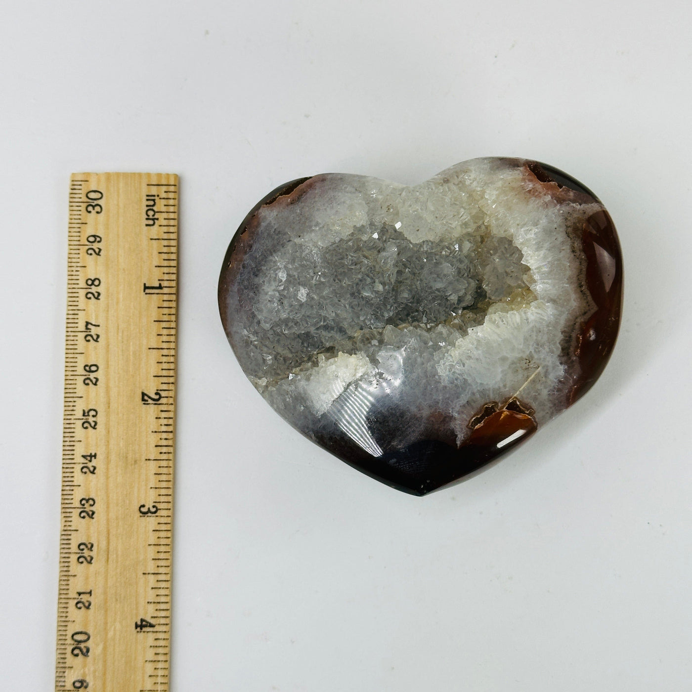 agate heart next to a ruler for size reference