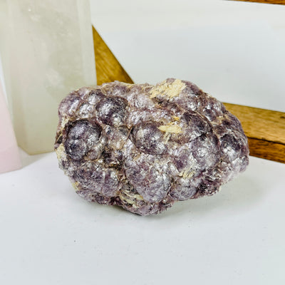 lepidolite with decorations in the background