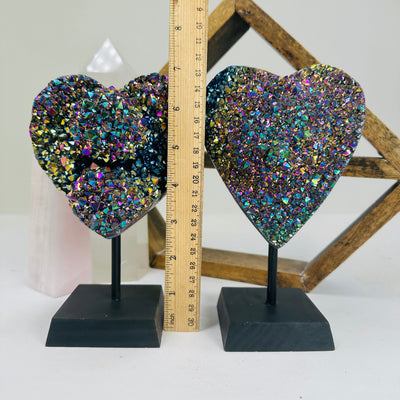 titanium coated heart on stand with decorations in the background