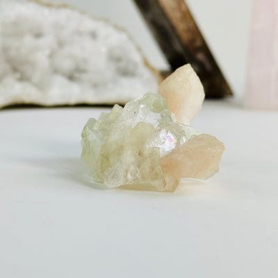  peach apophyllite with stilbite cluster with decorations in the background