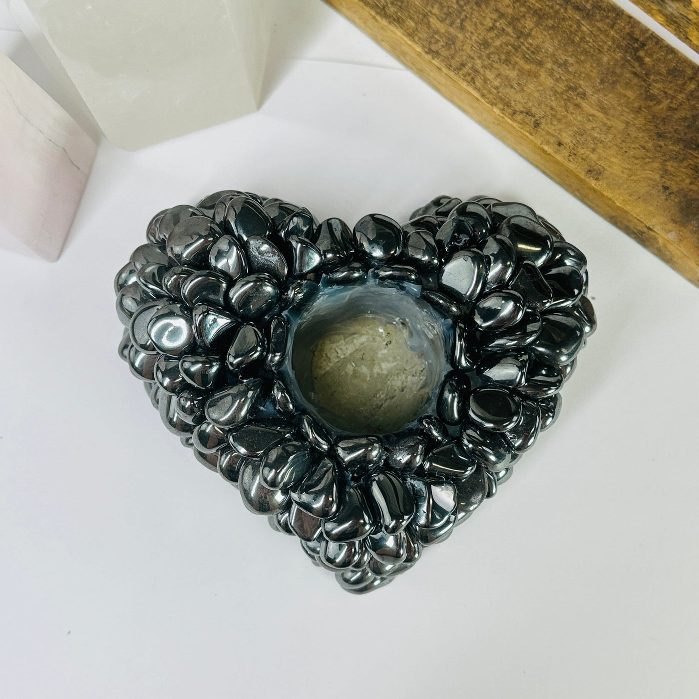 hematite candle holder with decorations in the background