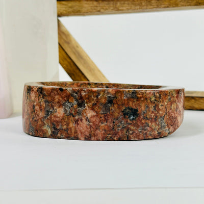 feldspar and tourmaline bowl with decorations in the background