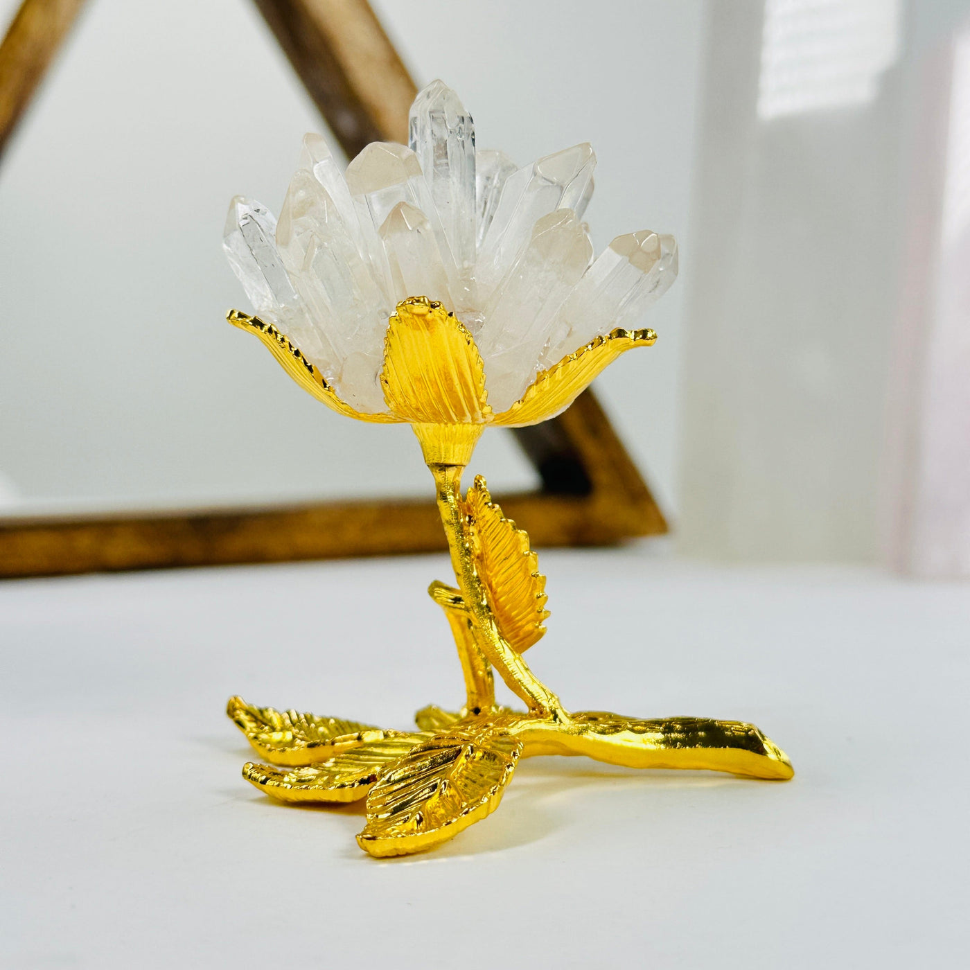 crystal quartz point rose with decorations in the background