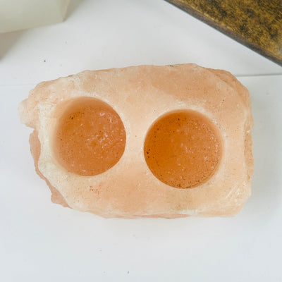 Himalayan salt candle holder with decorations in the background