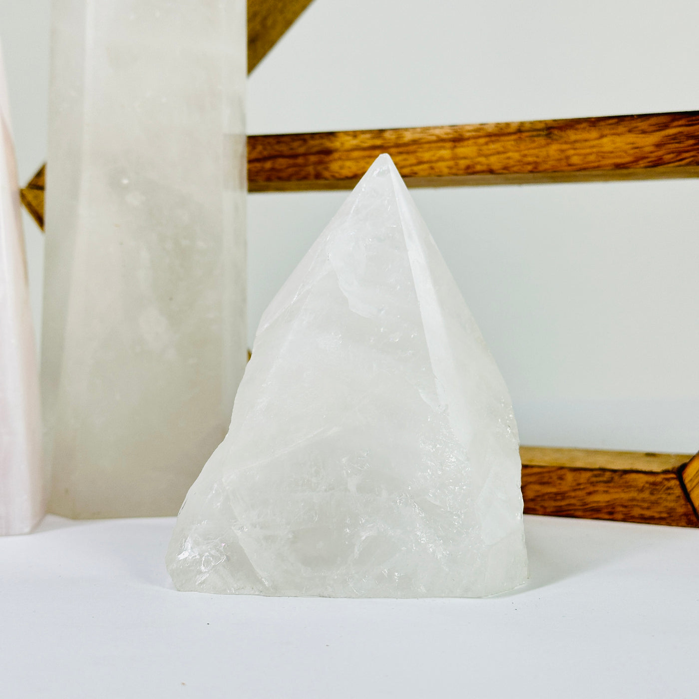 crystal quartz point with decorations in the background