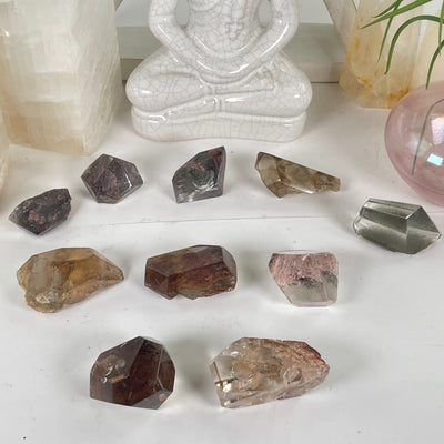 Garden Quartz Lodalite Polished Crystal Prisms laid out on a table