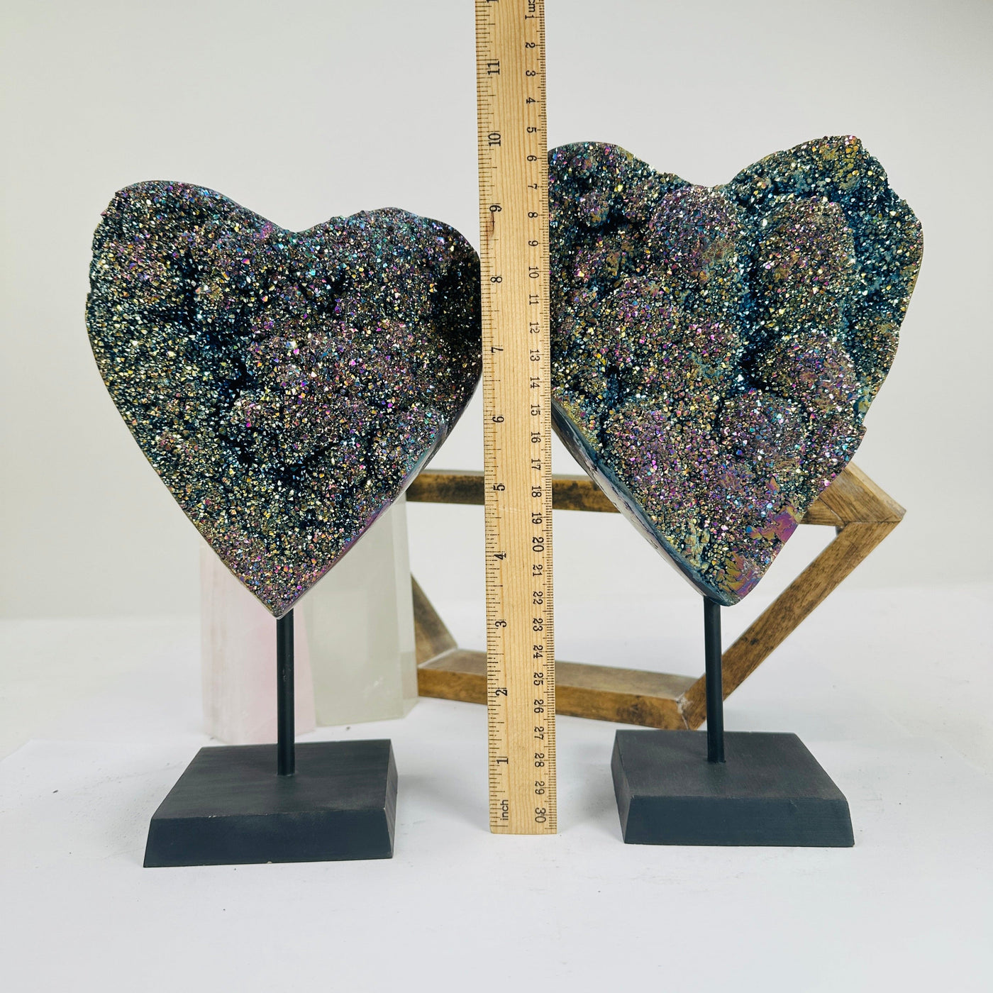 titanium coated heart on stand with decorations in the background