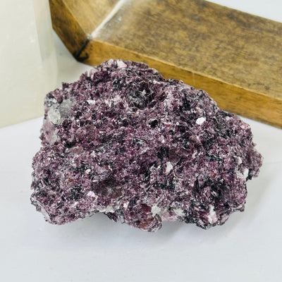 lepidolite cluster with decorations in the background