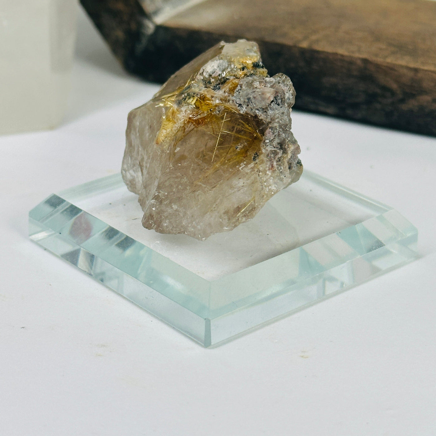 rutilated smokey quartz with decorations in the background