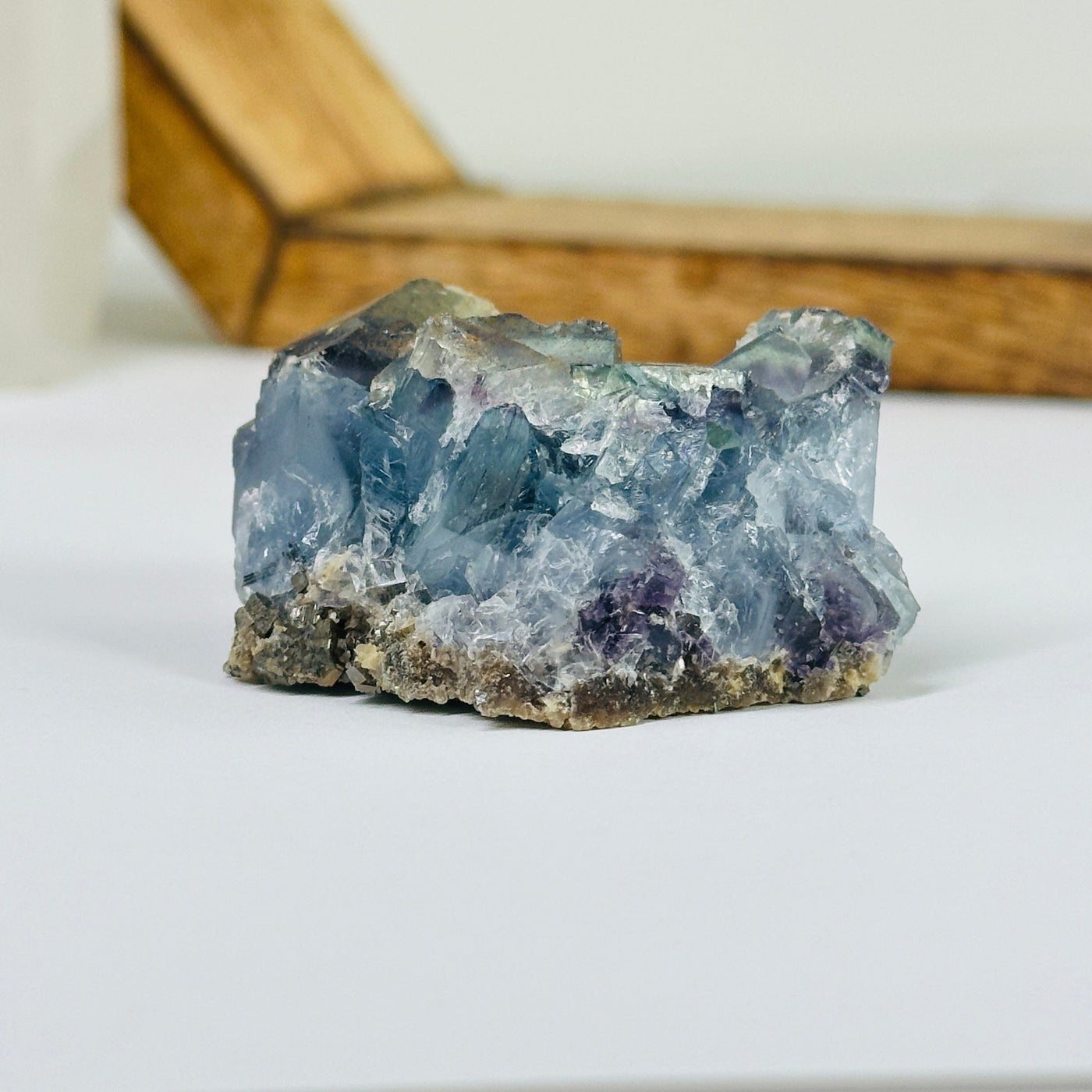 Blue fluorite crystal with decorations in the background