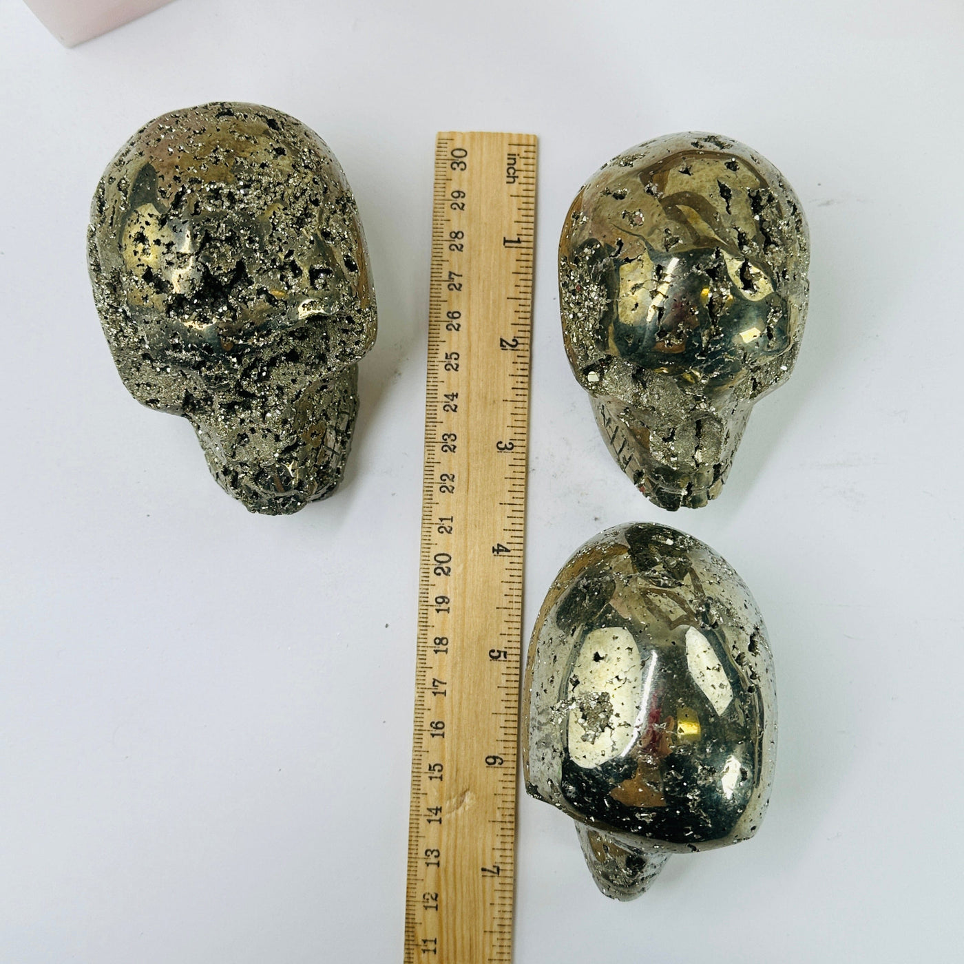 pyrite skulls next to a ruler for size reference