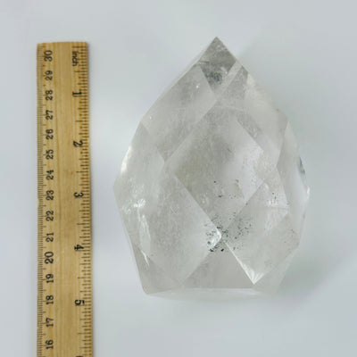 crystal quartz faceted egg next to a ruler for size reference
