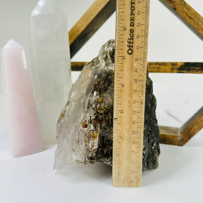 rutilated quartz with decorations in the background