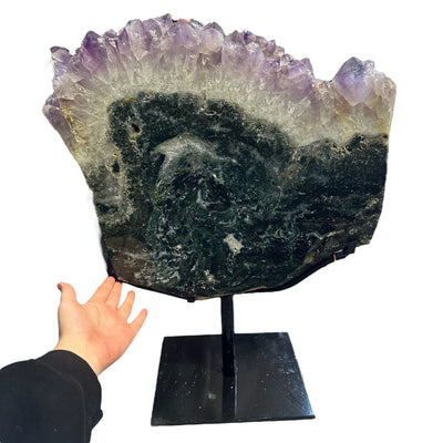 amethyst with jasper on metal stand on white background