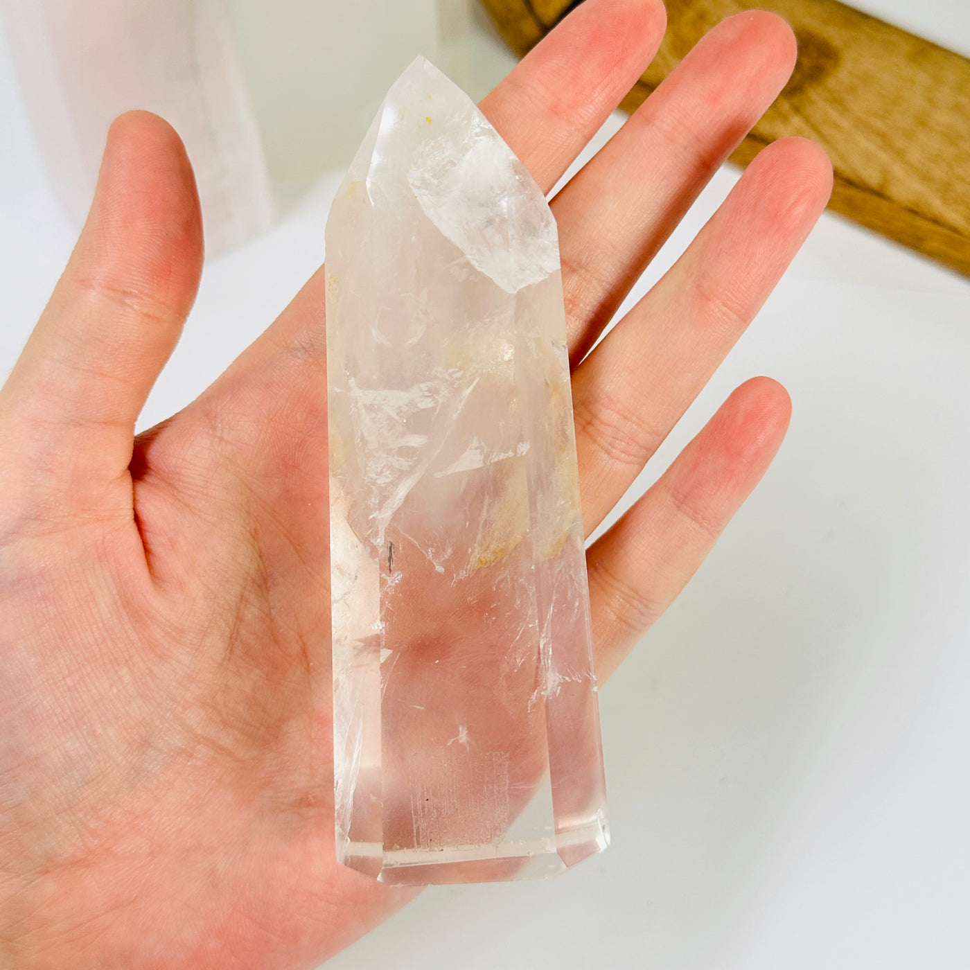 crystal quartz point with decorations in the background