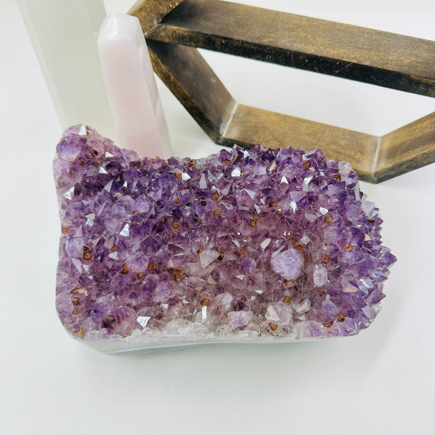 amethyst cluster with decorations in the background