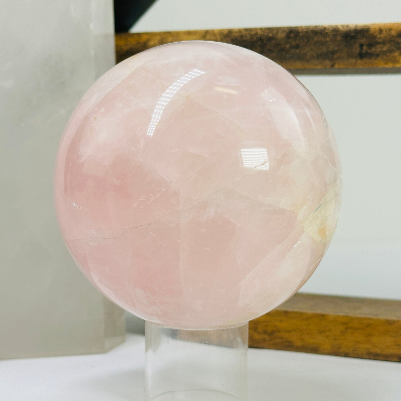 rose quartz sphere with decorations in the background