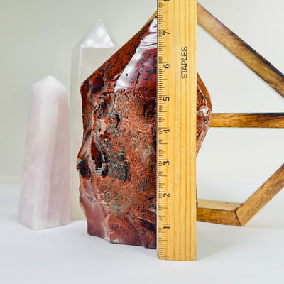 mahogany obsidian point next to a ruler for size reference