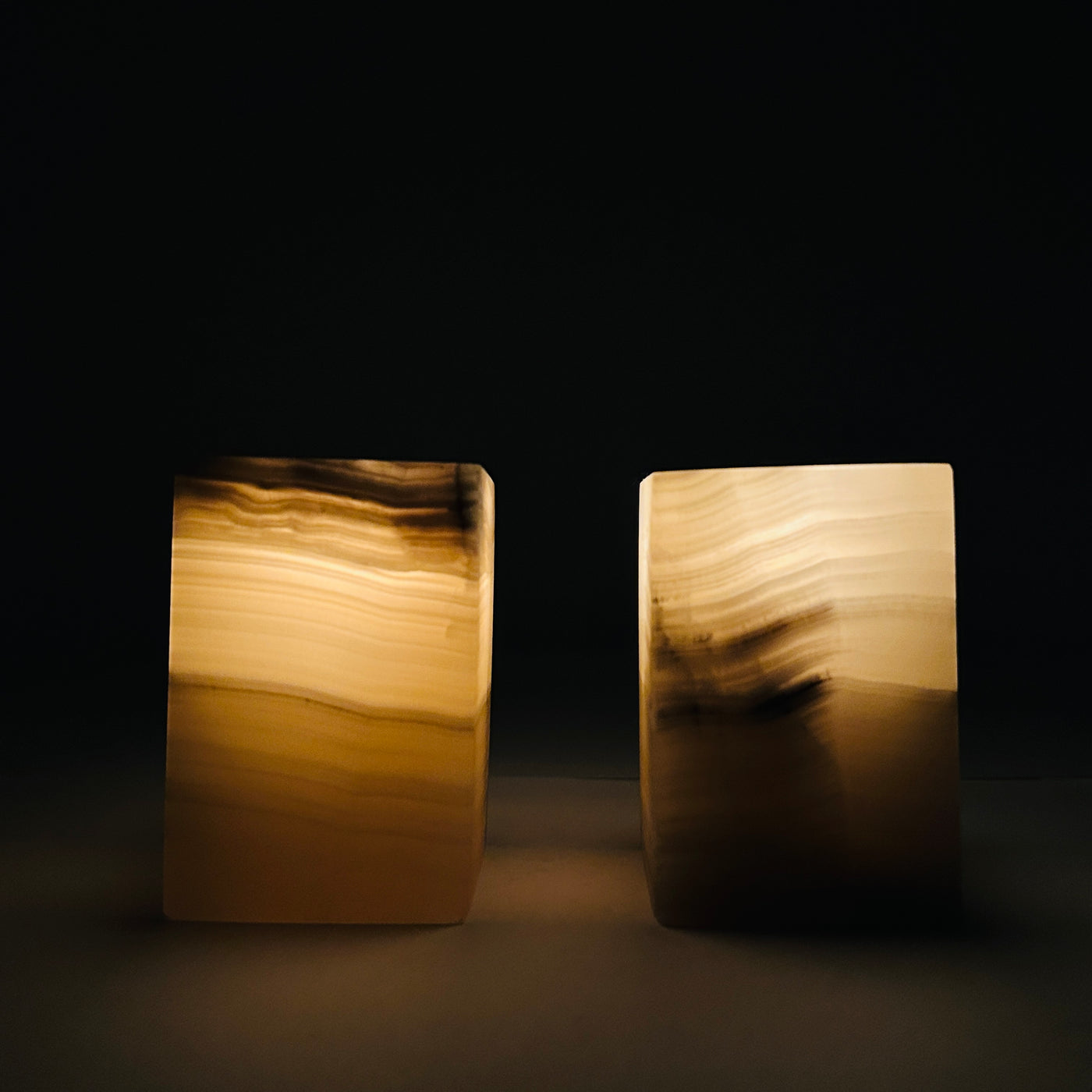 Mexican Onyx Crystal Candle Holders with a lit candle in a dark room.