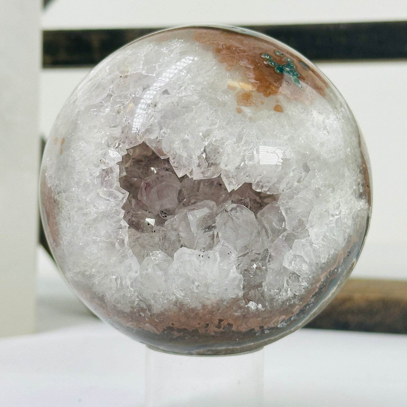 amethyst sphere with decorations in the background