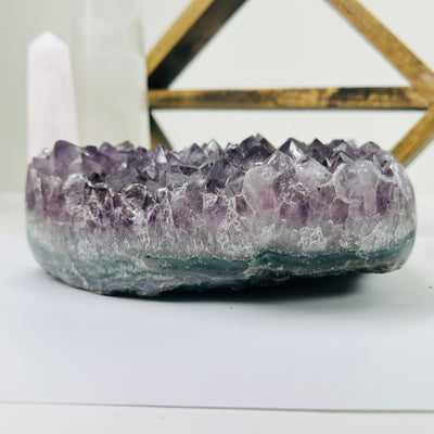 amethyst cluster with decorations in the background