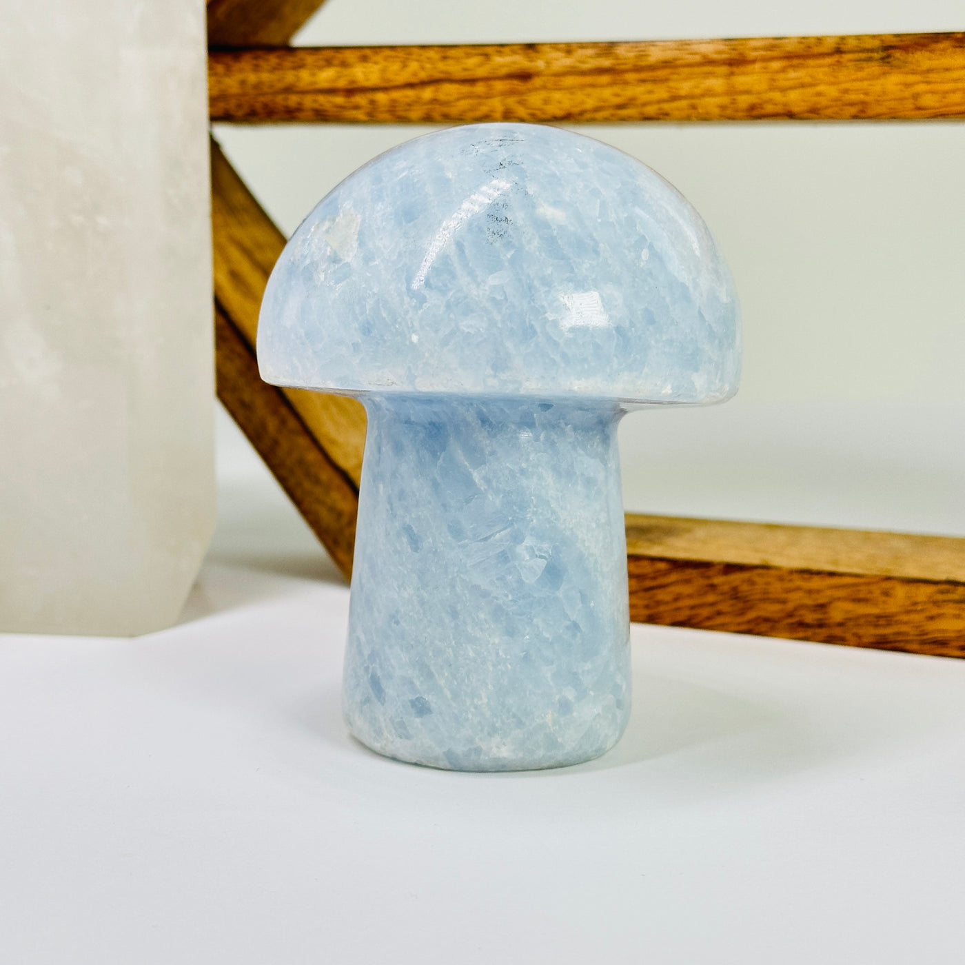 blue calcite mushroom with decorations in the background