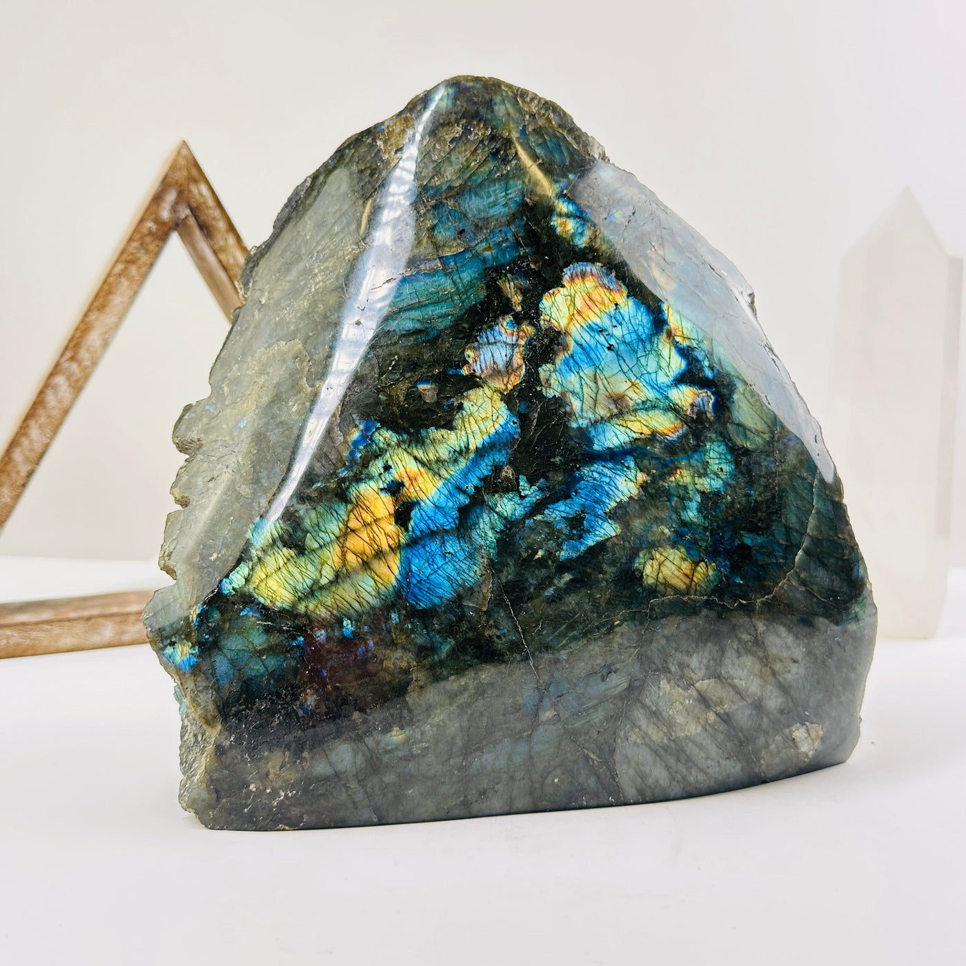 labradorite semi polished cut base with decorations in the background