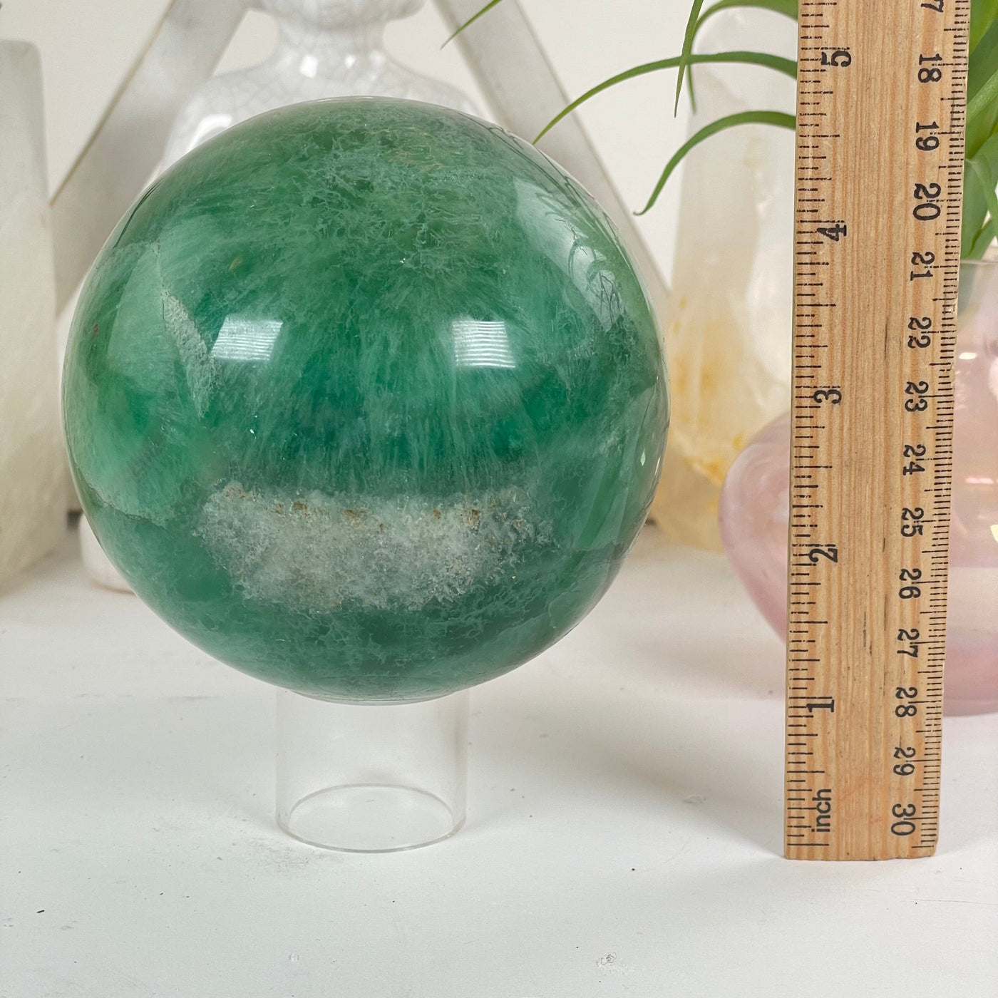 Fluorite Crystal Sphere next to a ruler for size reference