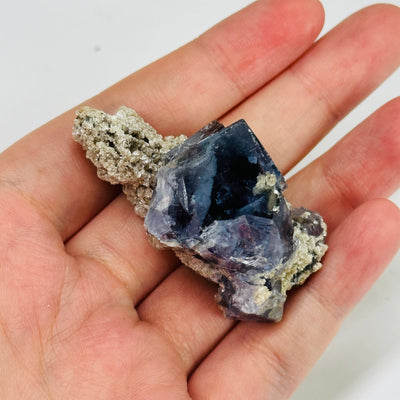 blue fluorite with decorations in the background