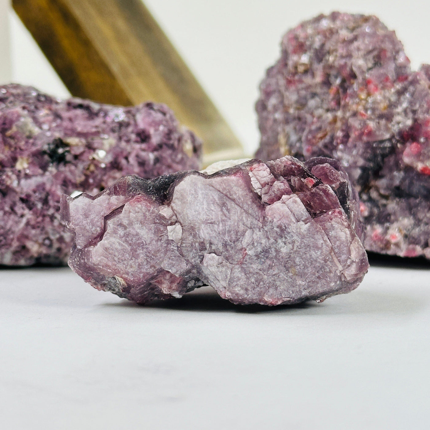 lepidolite cluster with decorations in the background