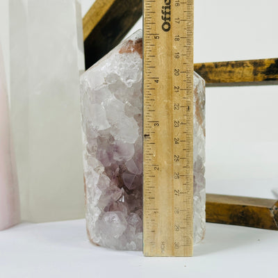 amethyst point next to a ruler for size reference