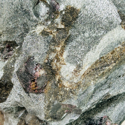 garnet on hematite matrix with decorations in the background