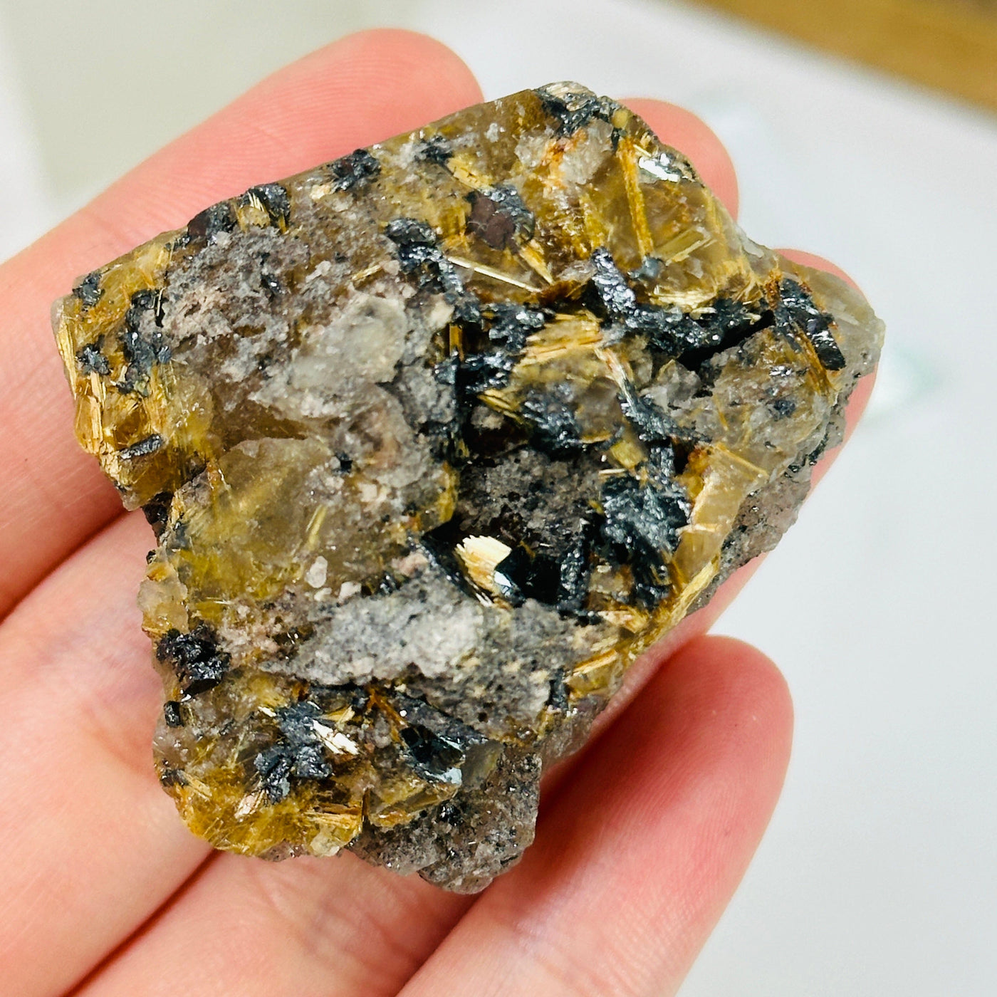 rutilated quartz with decorations in the background