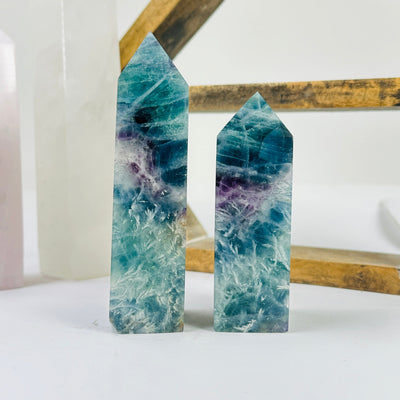 fluorite point with decorations in the background