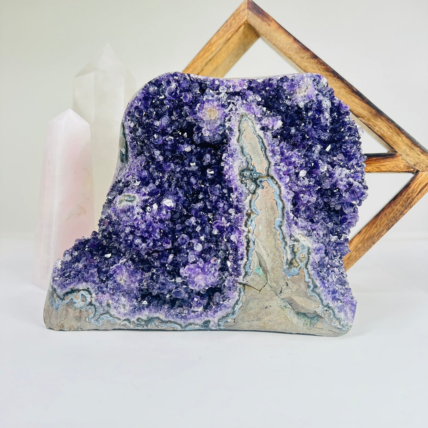 amethyst cluster with decorations in the background