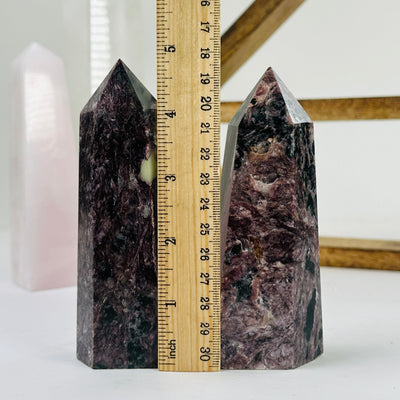charoite points with decorations in the background