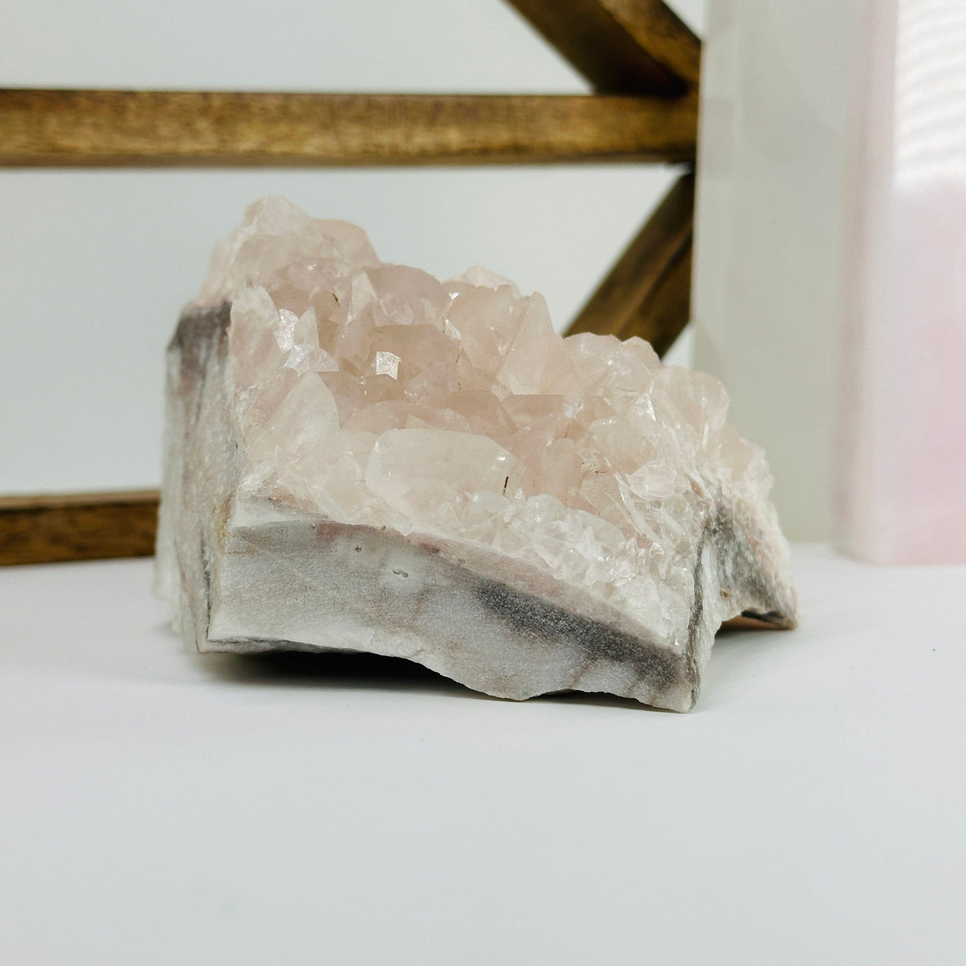 Pink chalcedony cluster with decorations in the background 