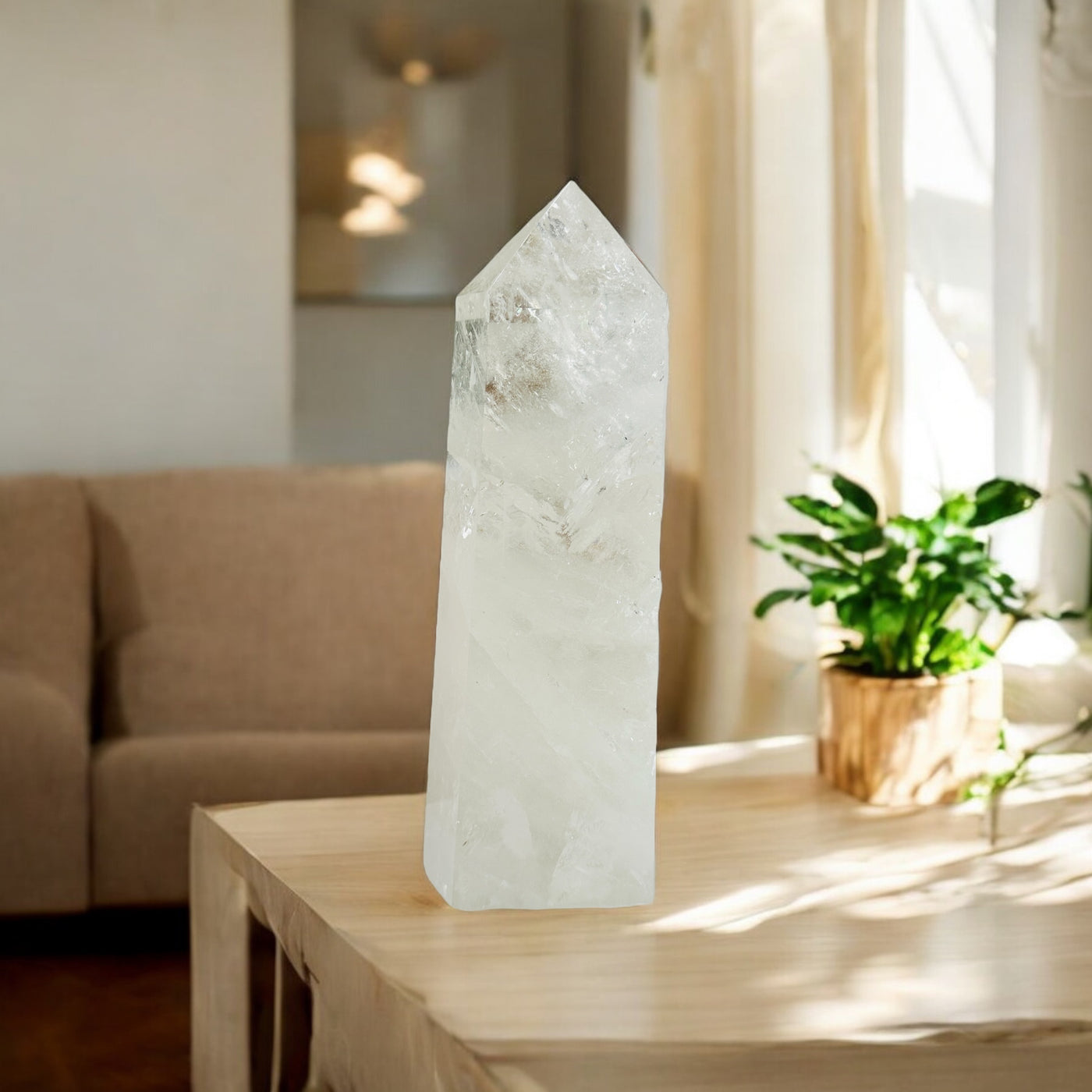 crystal quartz point with decorations in the background