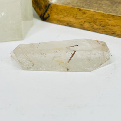 rutilated quartz with decorations in the background