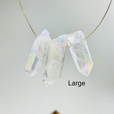 aura quartz crystal with decorations in the background