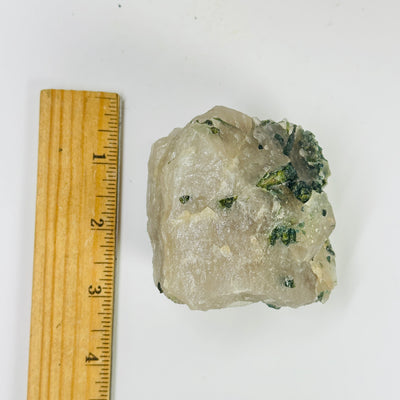 tourmaline next to a ruler for size reference