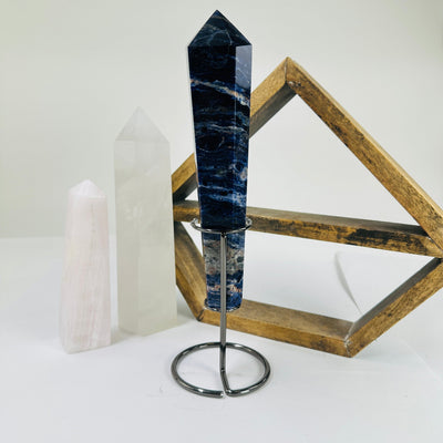 sodalite point with decorations in the background