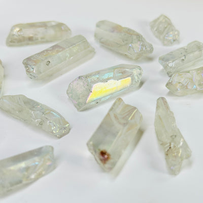 aura quartz crystal with decorations in the background