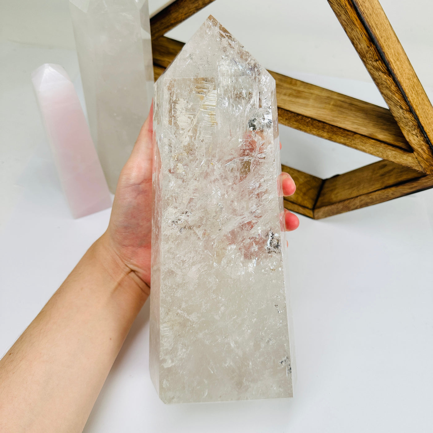 crystal quartz point with decorations in the background