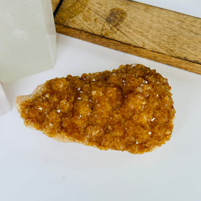 citrine cluster with decorations in the background